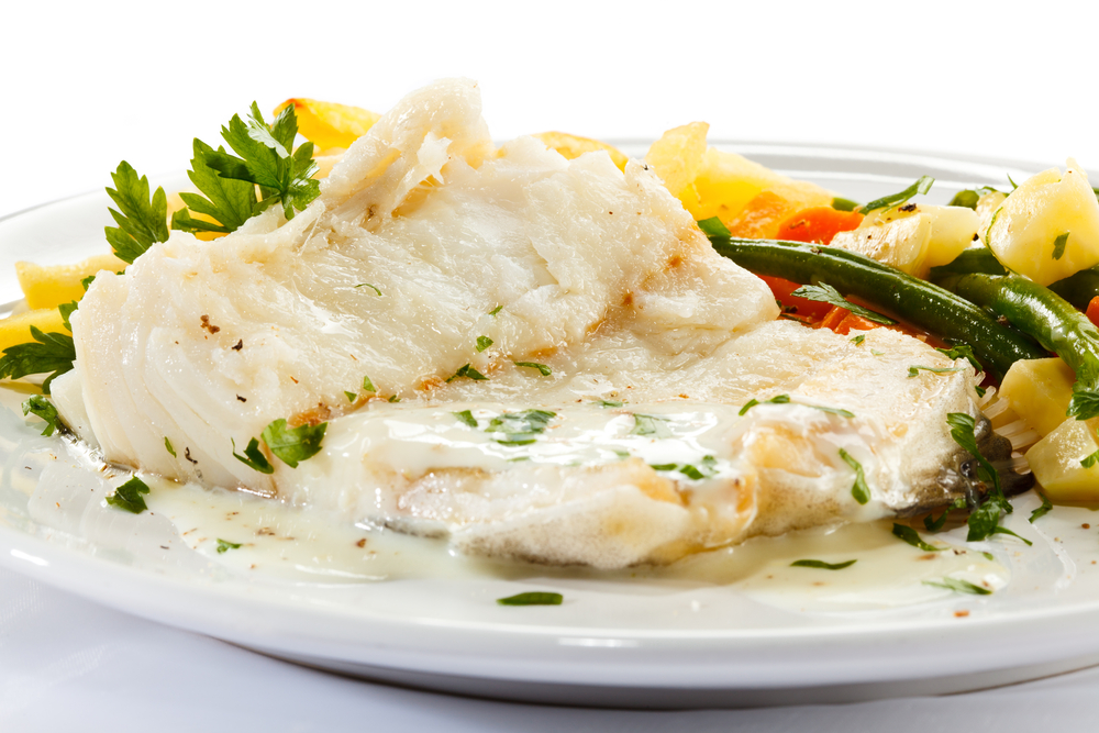 white fish with white sauce and potatoes